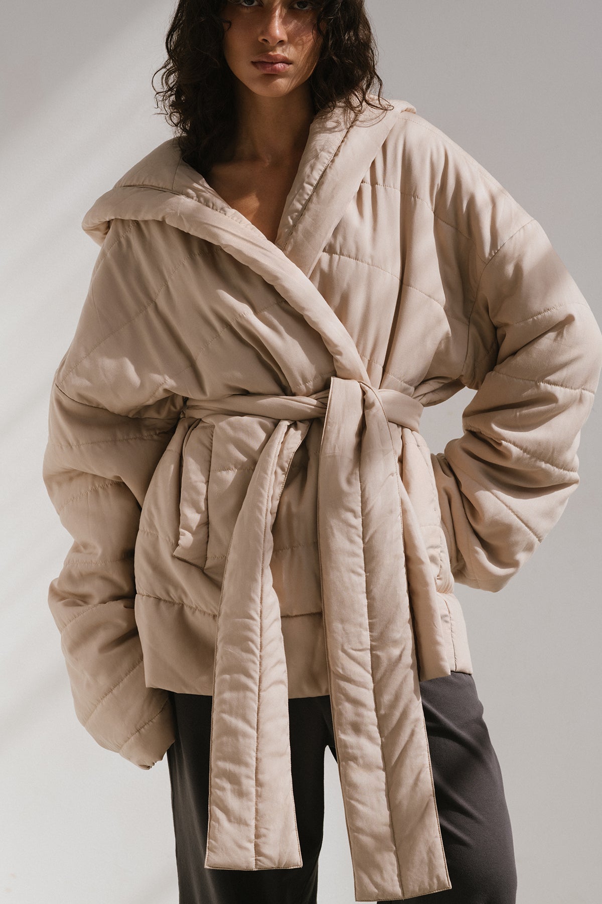 Short Doona Robe Oat worn by female model over Charcoal Cosy Pant, front view showing removable waist tie of robe