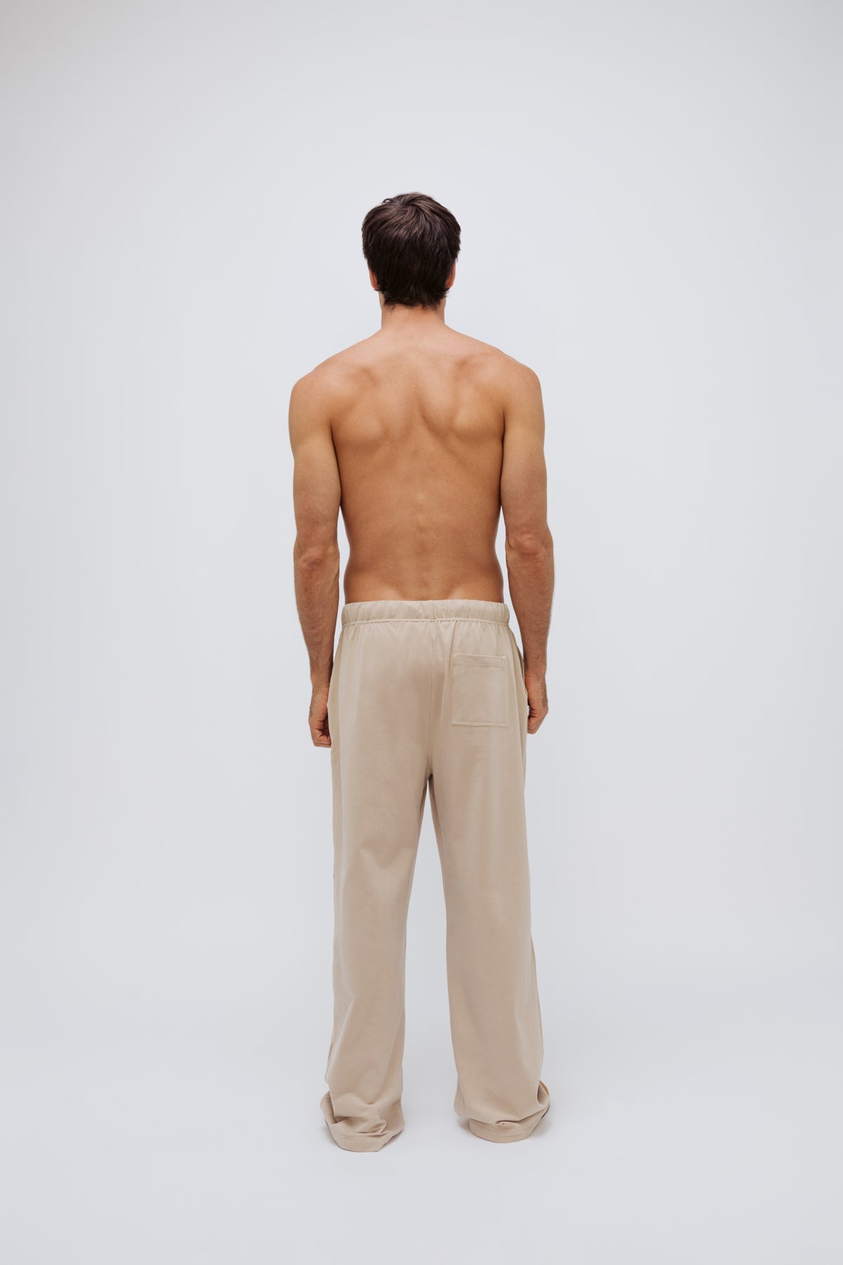The Cosy Pant in Latte worn by male model back view