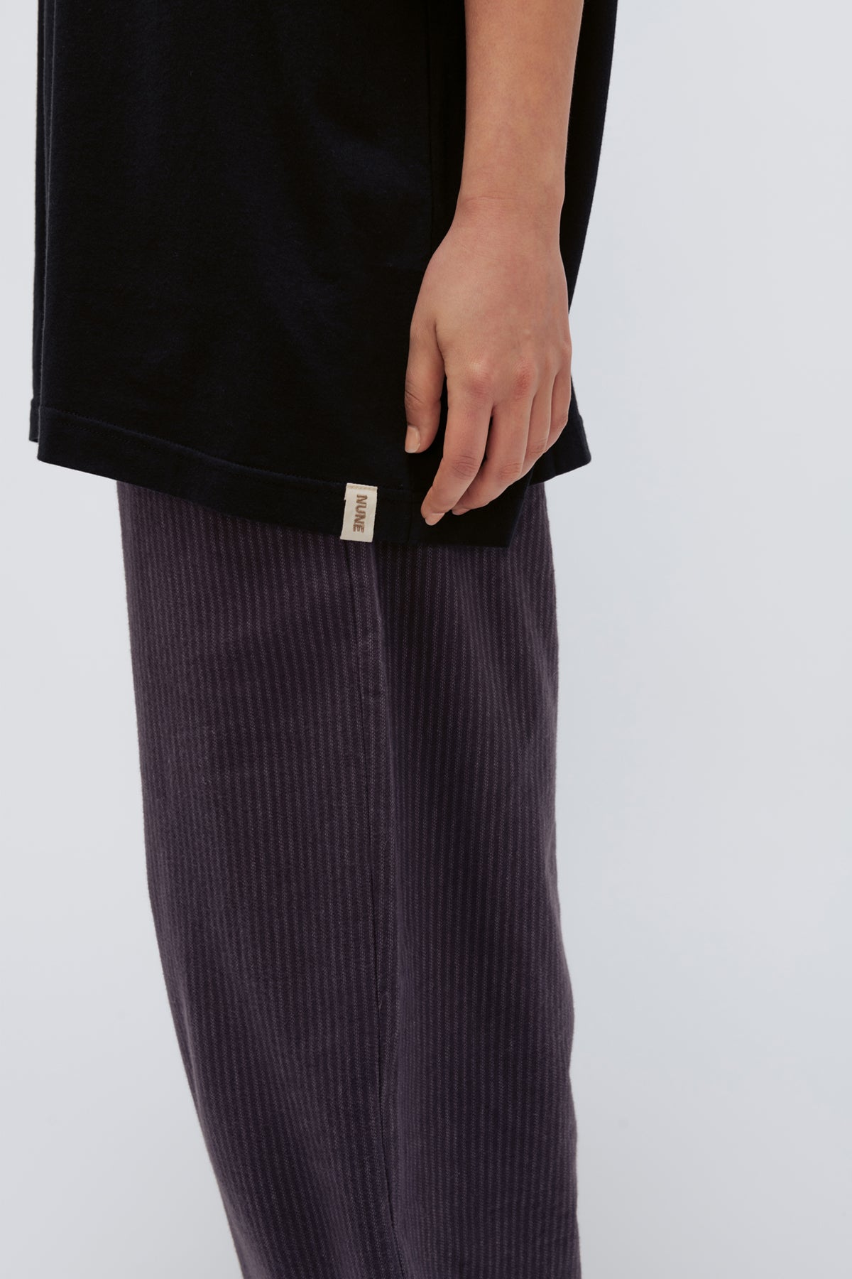 Black Oversized Tee in soft organic cotton jersey and Long Sleep Pant Flannel in Evening Pinstripe, cropped side view