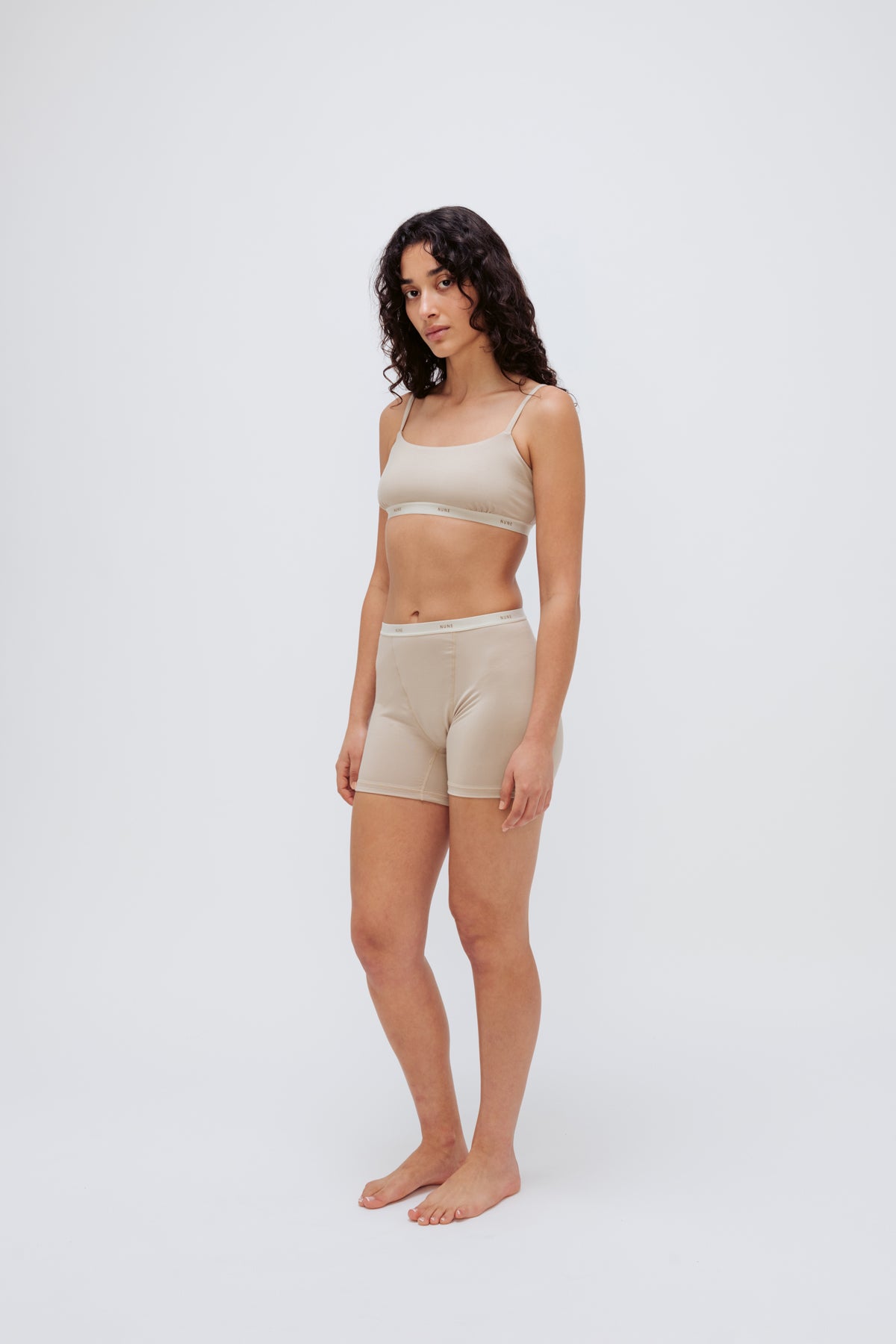 Women’s Boxer Brief in Latte silky-soft micromodal blend, like his Boxer Briefs, only cooler, and Square Neck Bralette in Latte worn by female model, front view