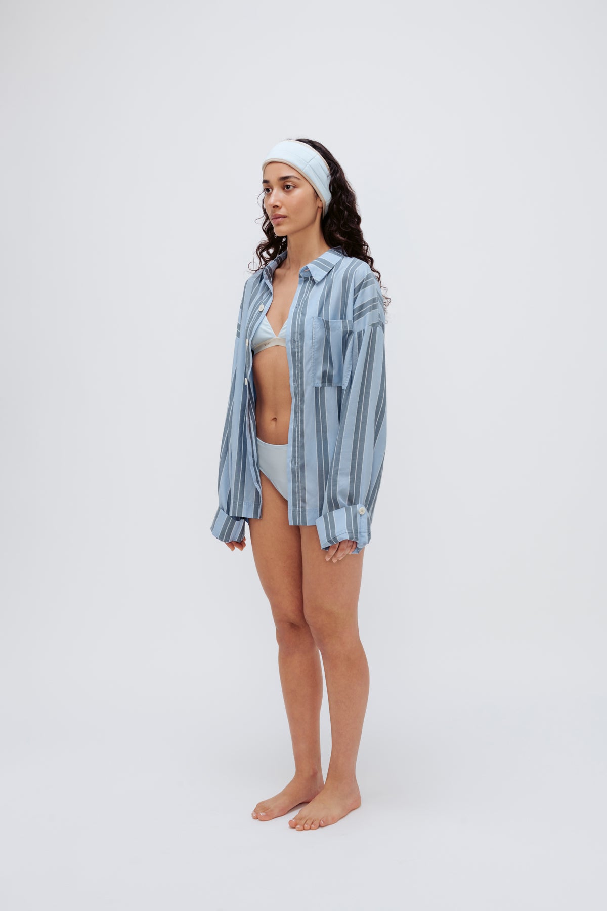 Blue Daybreak Stripe Long Sleeve Sleep Shirt in Macel worn by model over daybreak triangle bralette and mid brief. Model also wearing blue micromodal blend headband - side view