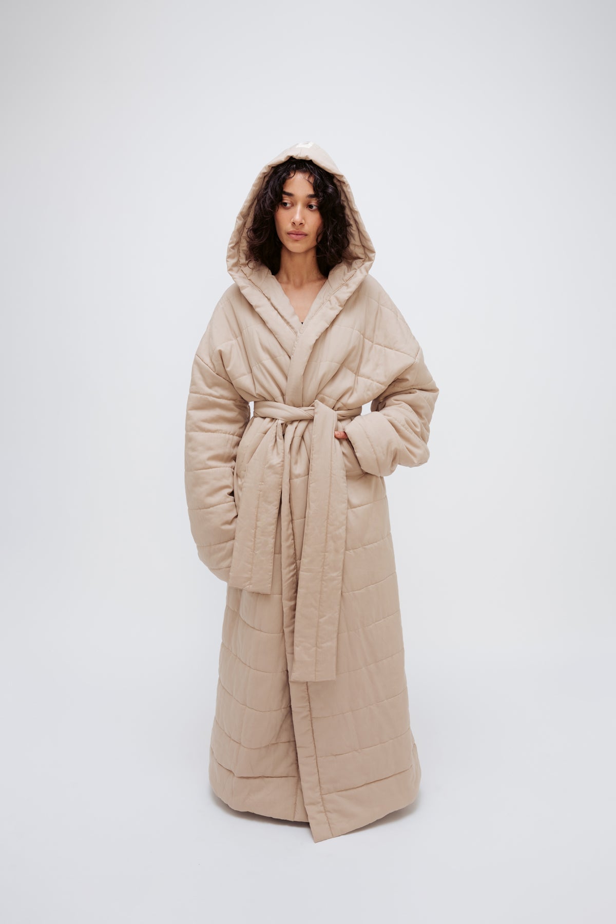 Long Doona Robe Oat worn by female model, front view showing removable waist tie, front pockets and super long length.