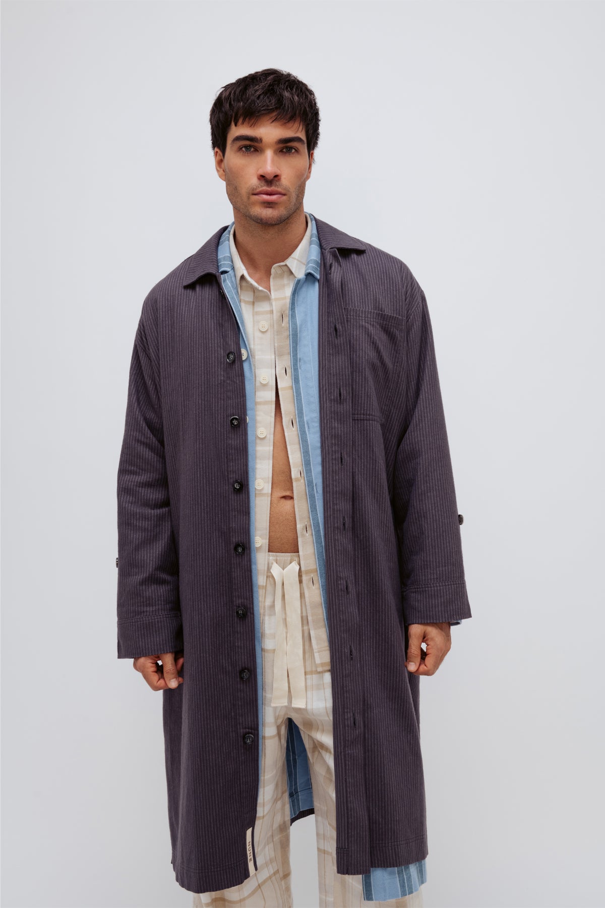 Long House Shirts in Evening Pinstripe and Daybreak Stripe worn layered over Oat Check Sleep Shirt and Flannel sleep pants by male model facing front