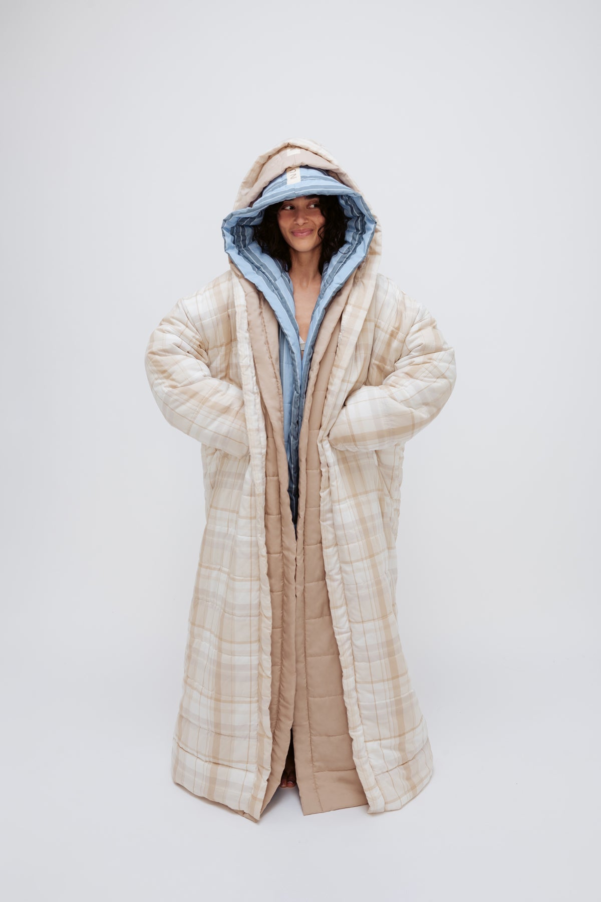 Long Doona Robes in Daybreak Stripe, Oat and Oat Check worn layered by female model smiling, full length view showing super long length of robes
