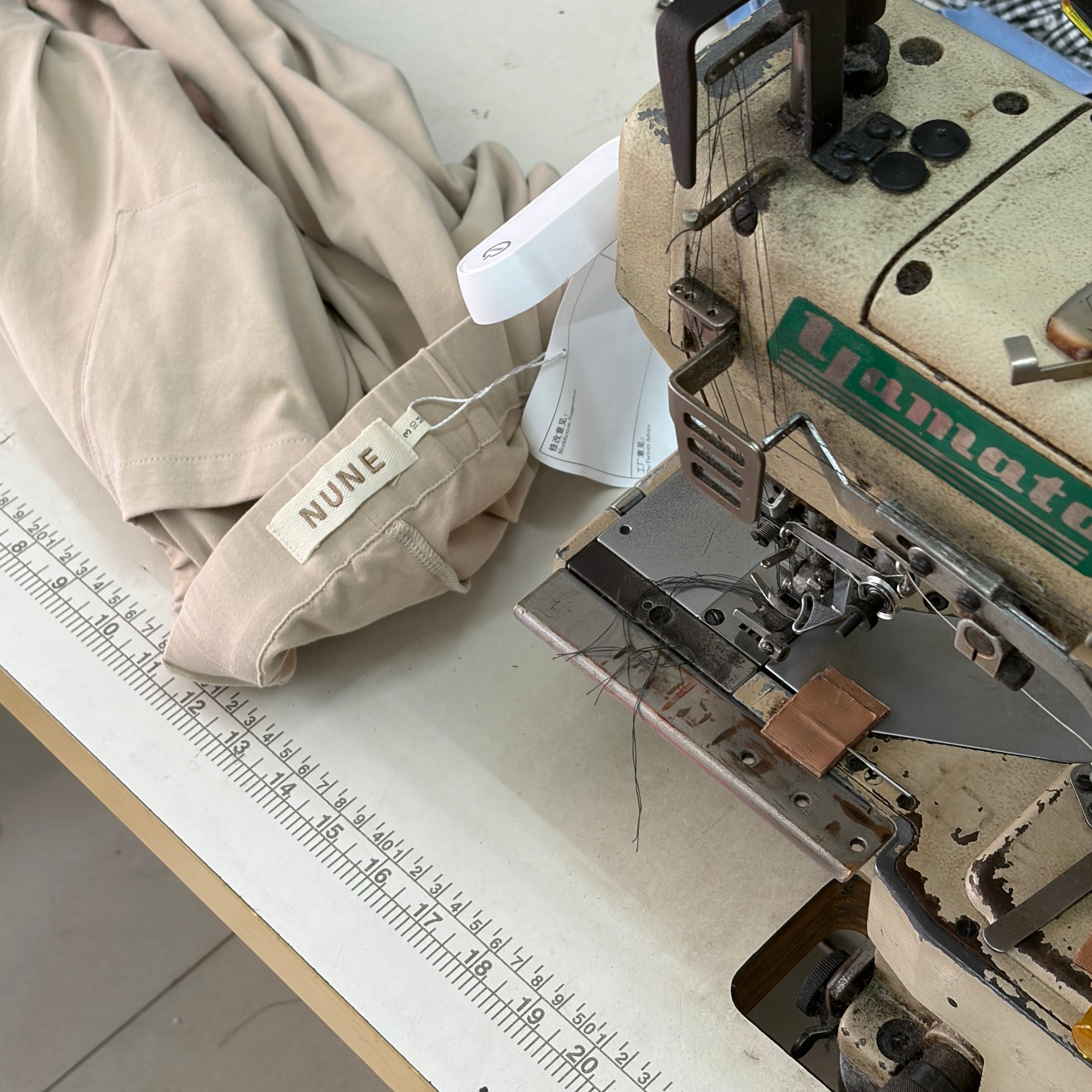 Garment being sewn in a garment factory with a sewing machine