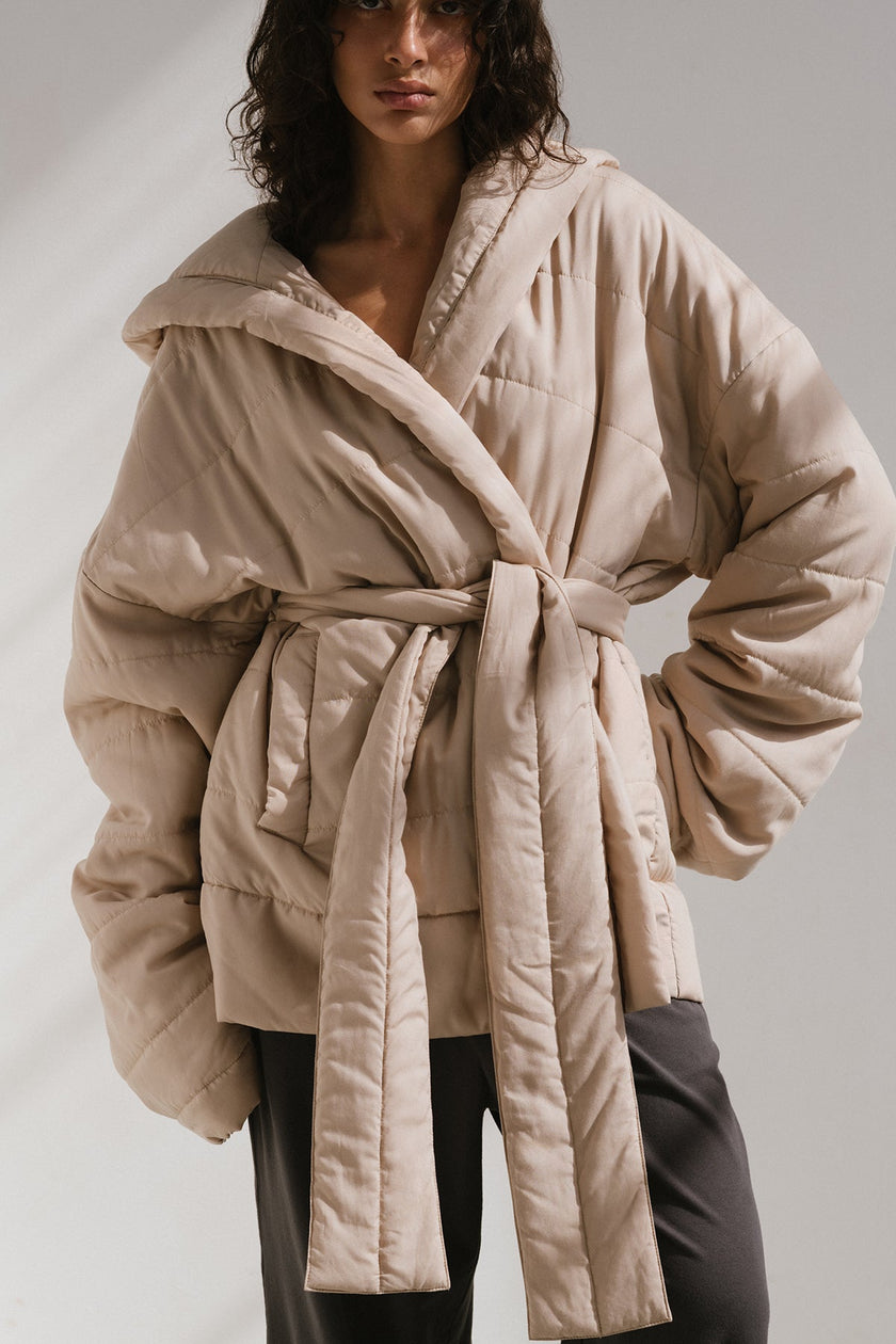 Short Doona Robe Oat worn by female model over Charcoal Cosy Pant, front view showing removable waist tie of robe