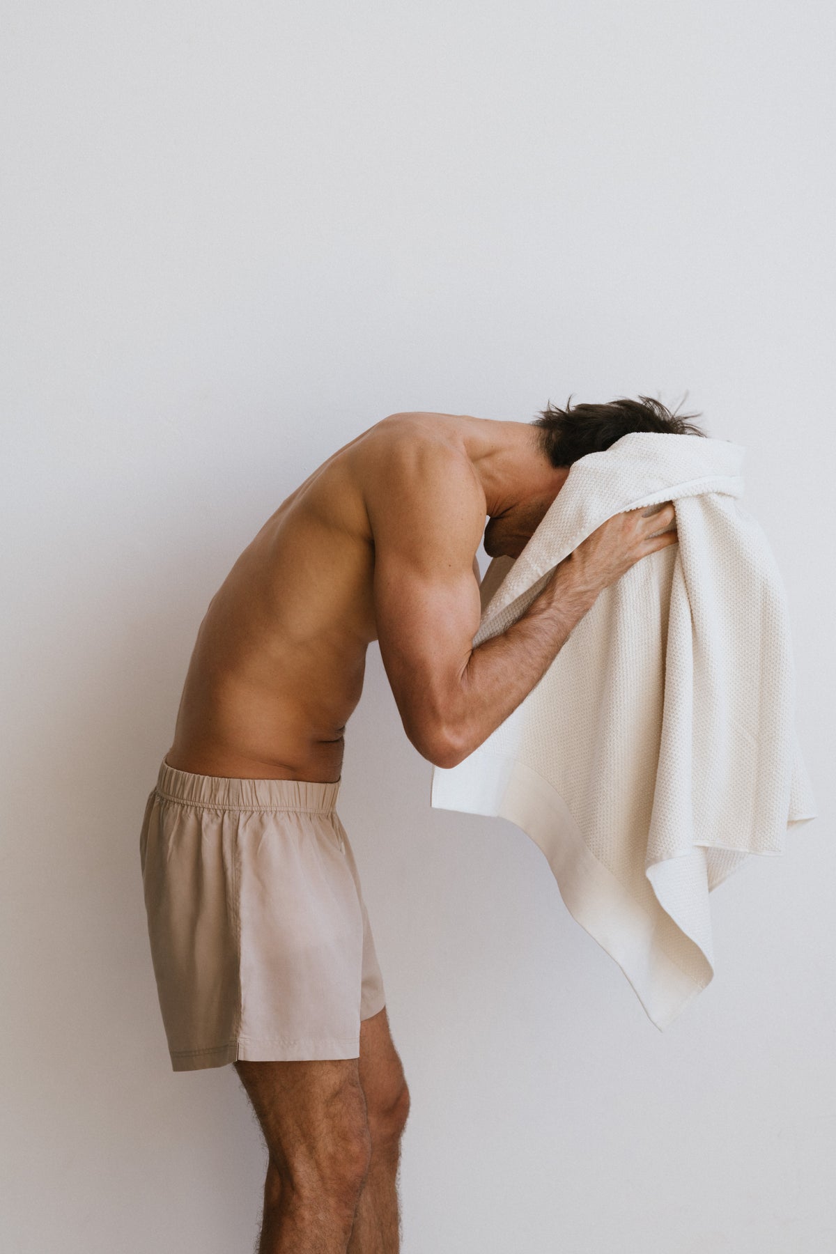 Oat Boxer Shorts worn by male model bent over and drying hair with white towel