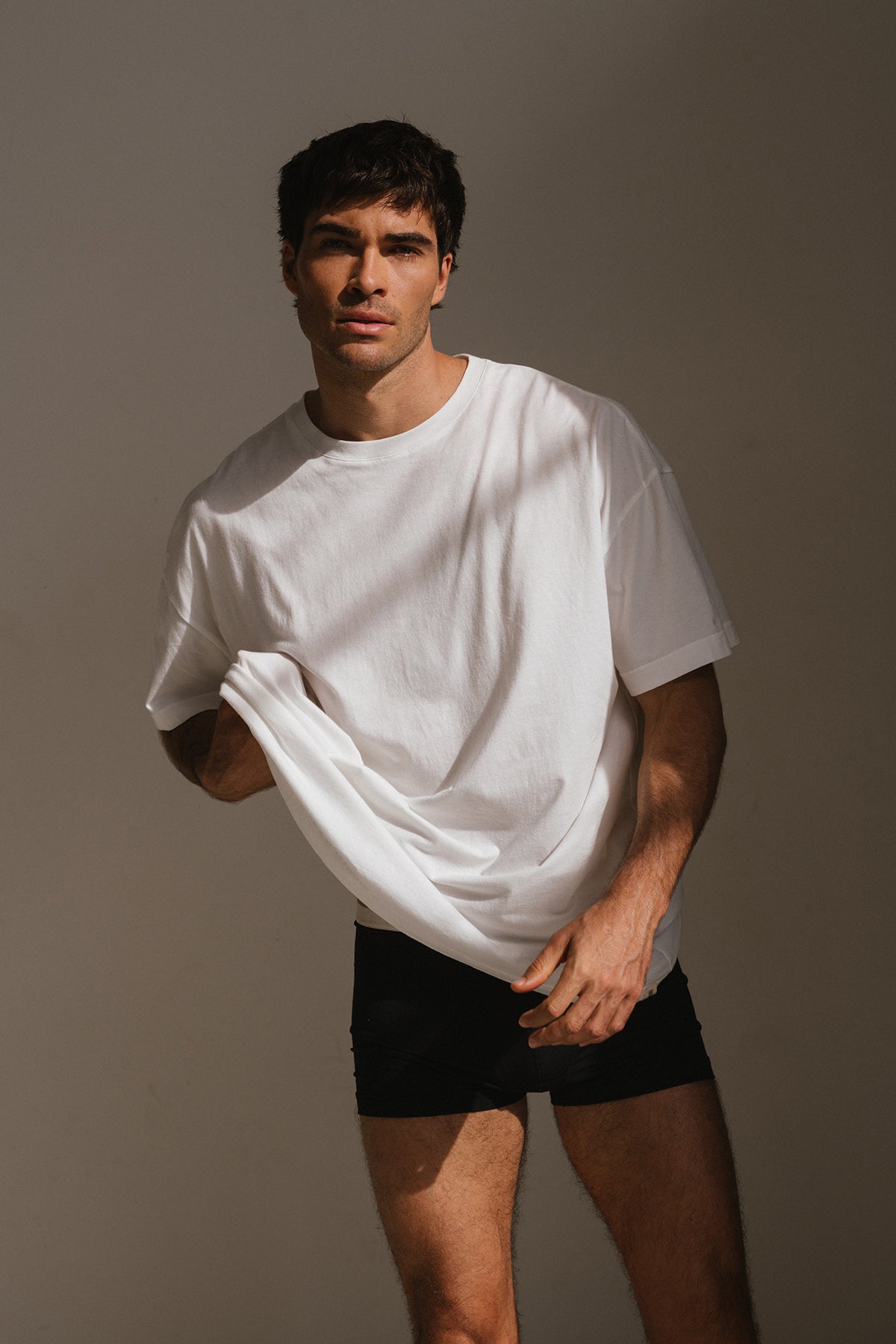 White Oversized Tee with a drop-shoulder silhouette made in organic cotton jersey and Black Original Boxer Briefs worn by male model, front view