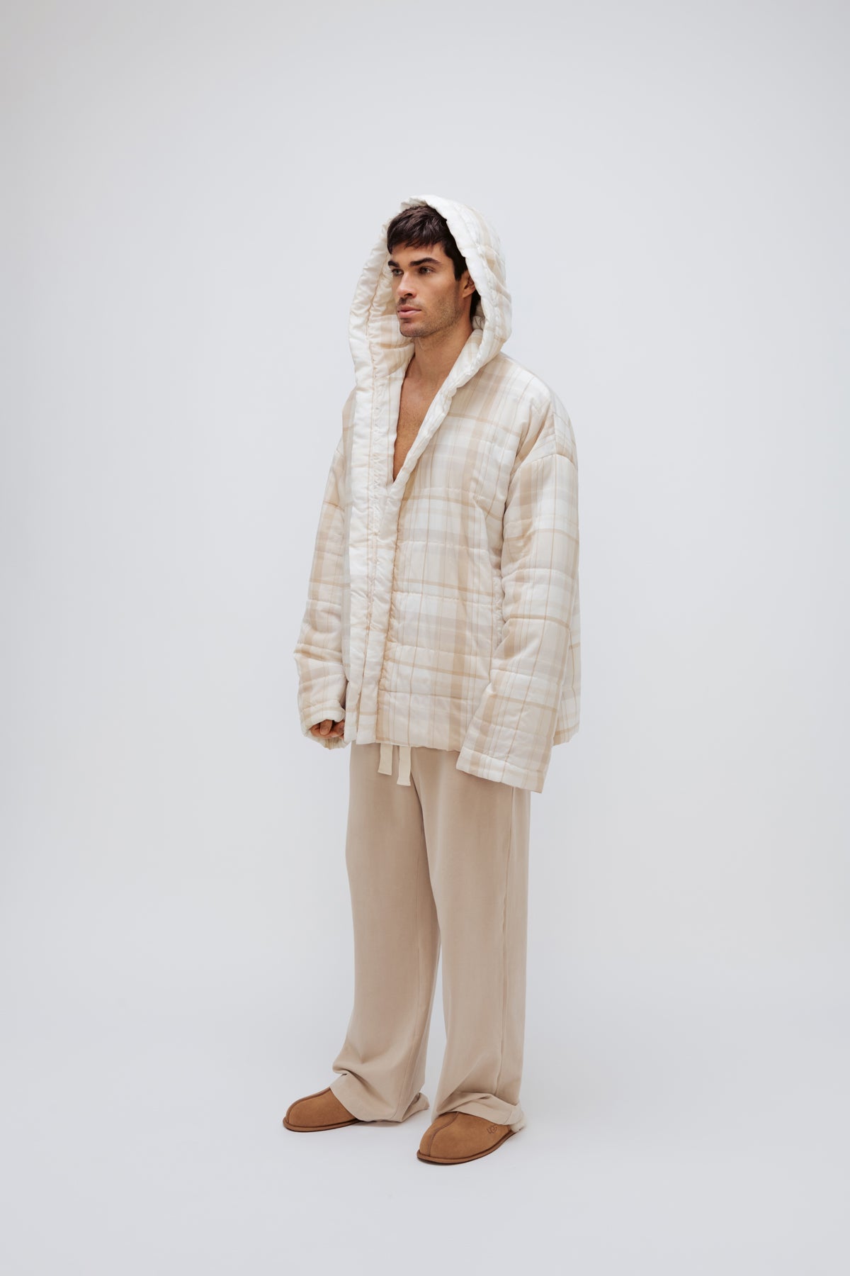 Oat Check Short Doona Robe and Cosy Pant in Oat worn by male model standing side view with hood up over his head