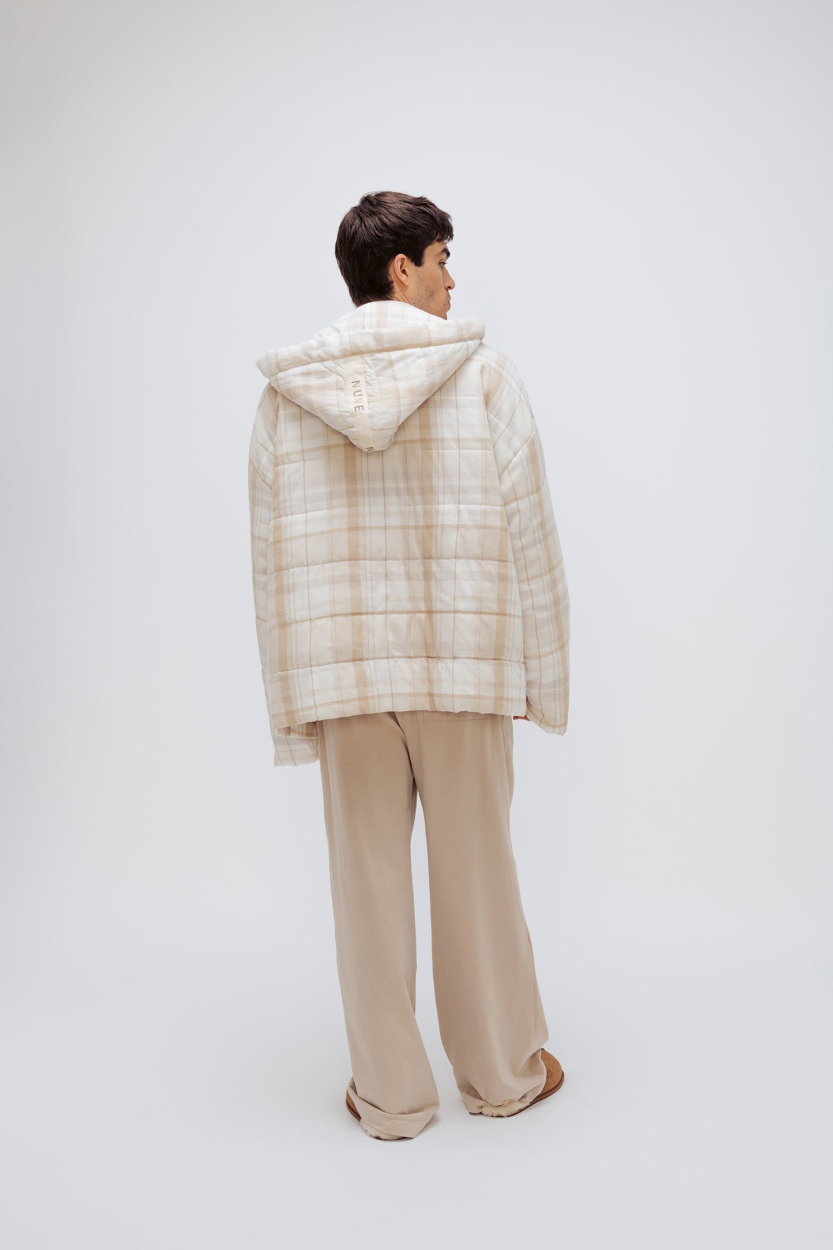 Oat Check Short Doona Robe and Cosy Pant in Oat worn by male model standing back view showing hood of Robe