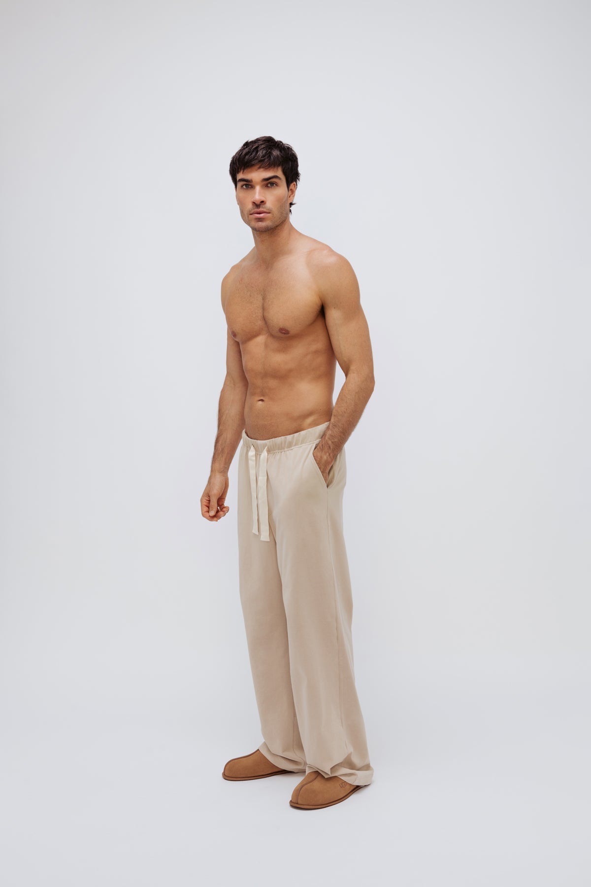 The Cosy Pant in Latte worn by male model front side view