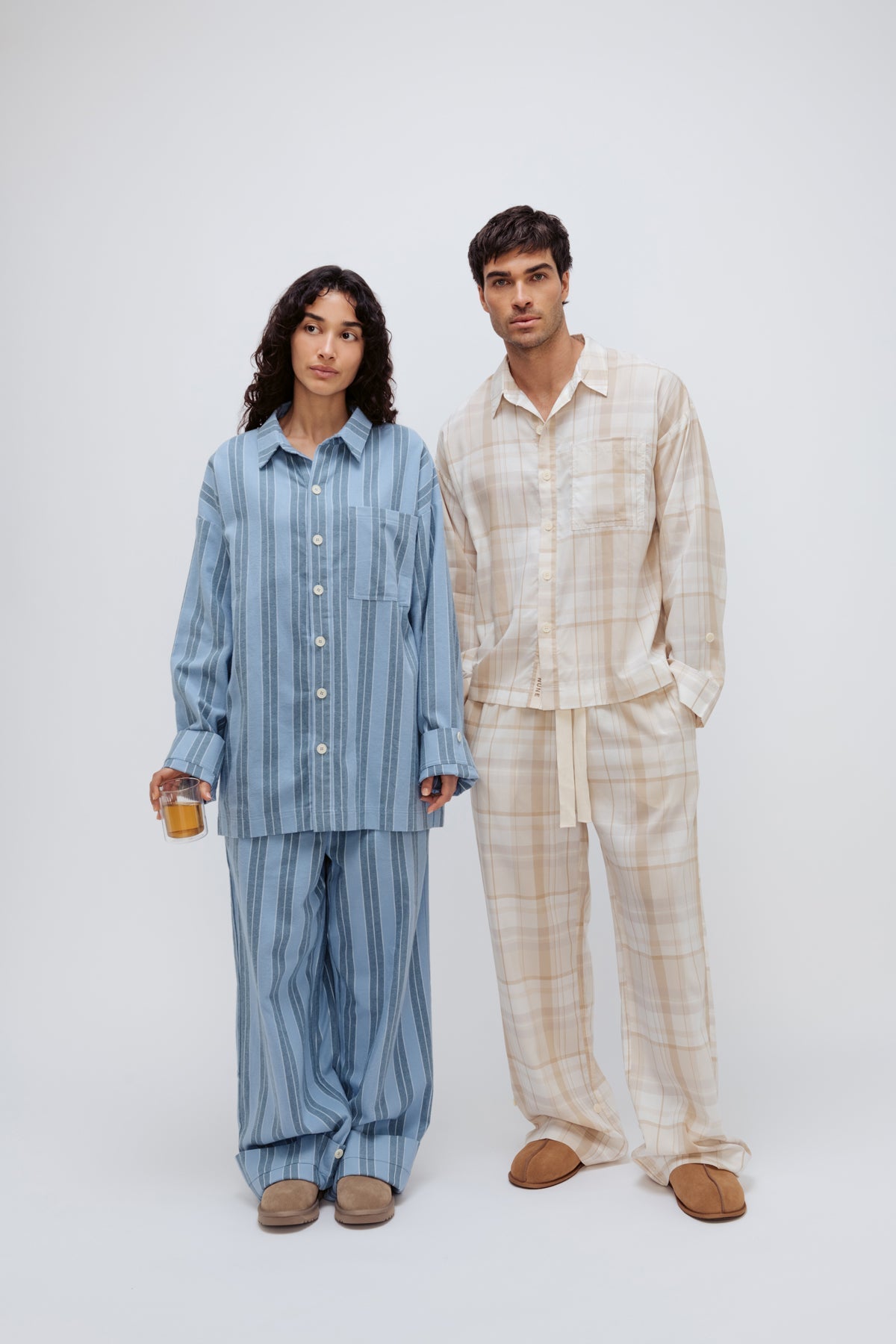 Long Sleeve Sleep Shirt and Long Sleep Pants in Daybreak Stripe Flannel worn by female model, and Long Sleeve Sleep Shirt and Long Sleep Pants in Oat Check Macel worn by male model, front view