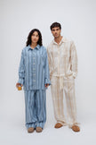 Long Sleeve Sleep Shirt and Long Sleep Pants in Daybreak Stripe Flannel worn by female model, and Long Sleeve Sleep Shirt and Long Sleep Pants in Oat Check Macel worn by male model, front view