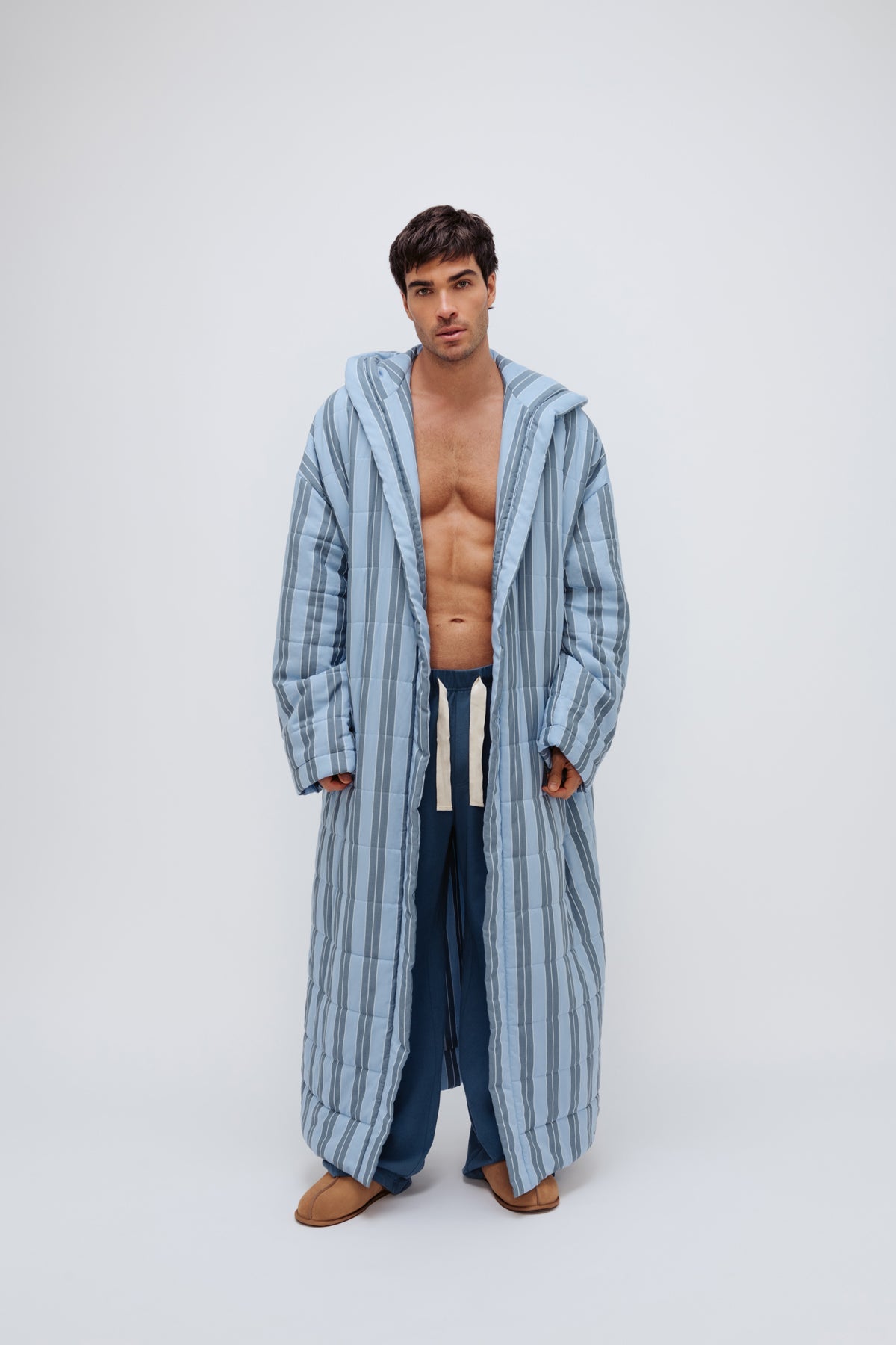 Long Doona Robe in Daybreak Stripe and Cosy Pant in Noon worn by male model front view showing super long length of robe and natural cotton waist tie on pant