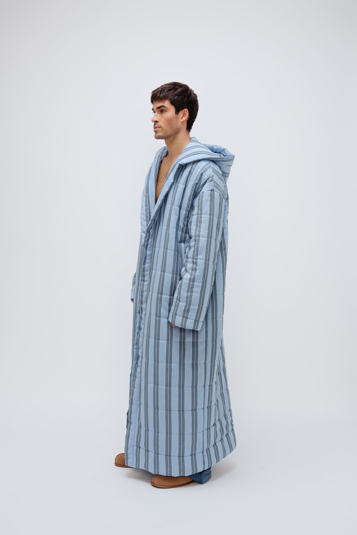 Long Doona Robe in Daybreak Stripe and Cosy Pant in Noon worn by male model side view showing long sleeve length of robe