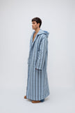 Long Doona Robe in Daybreak Stripe and Cosy Pant in Noon worn by male model side view showing long sleeve length of robe