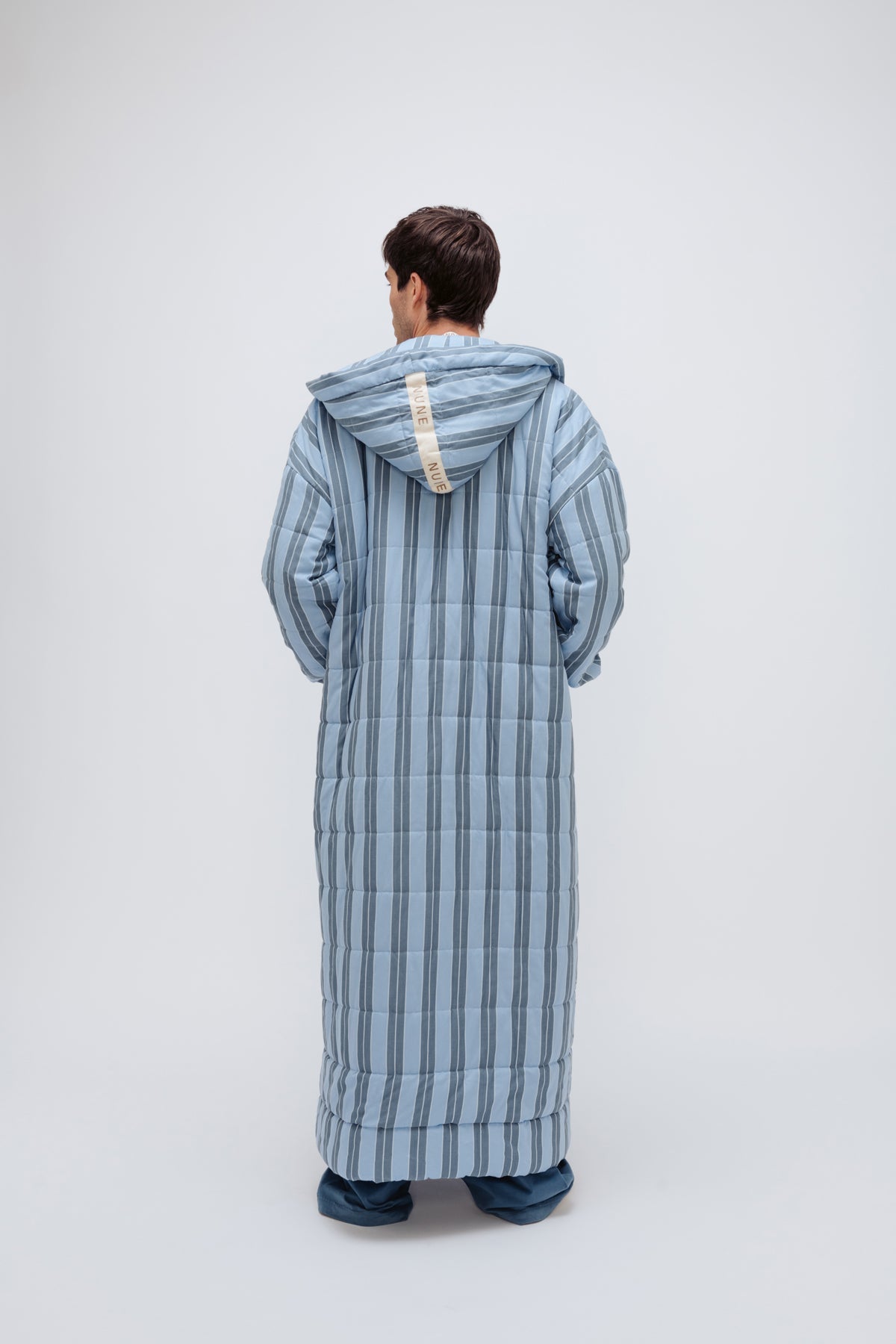 Long Doona Robe in Daybreak Stripe and Cosy Pant in Noon worn by male model back view showing hood of robe