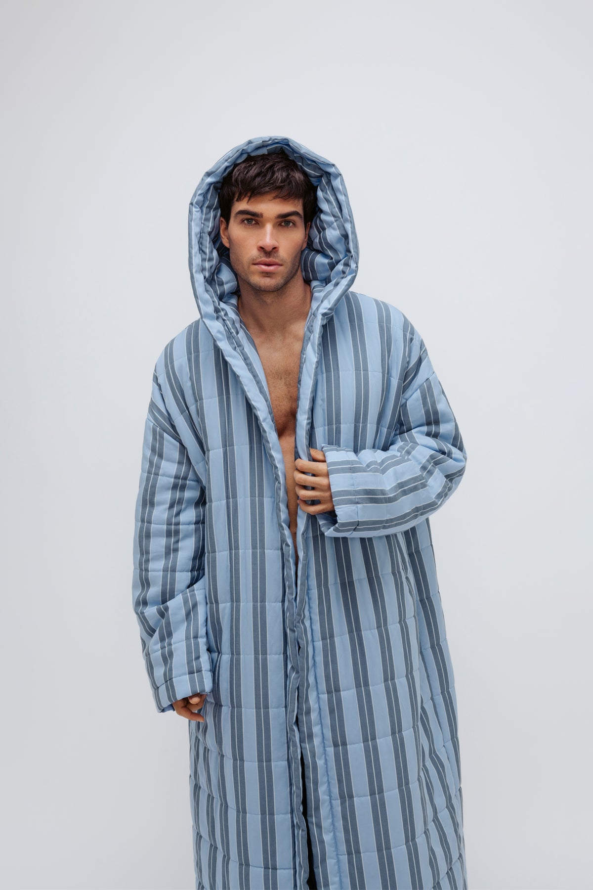 Long Doona Robe in Daybreak Stripe worn by male model front view with hood pulled over his head