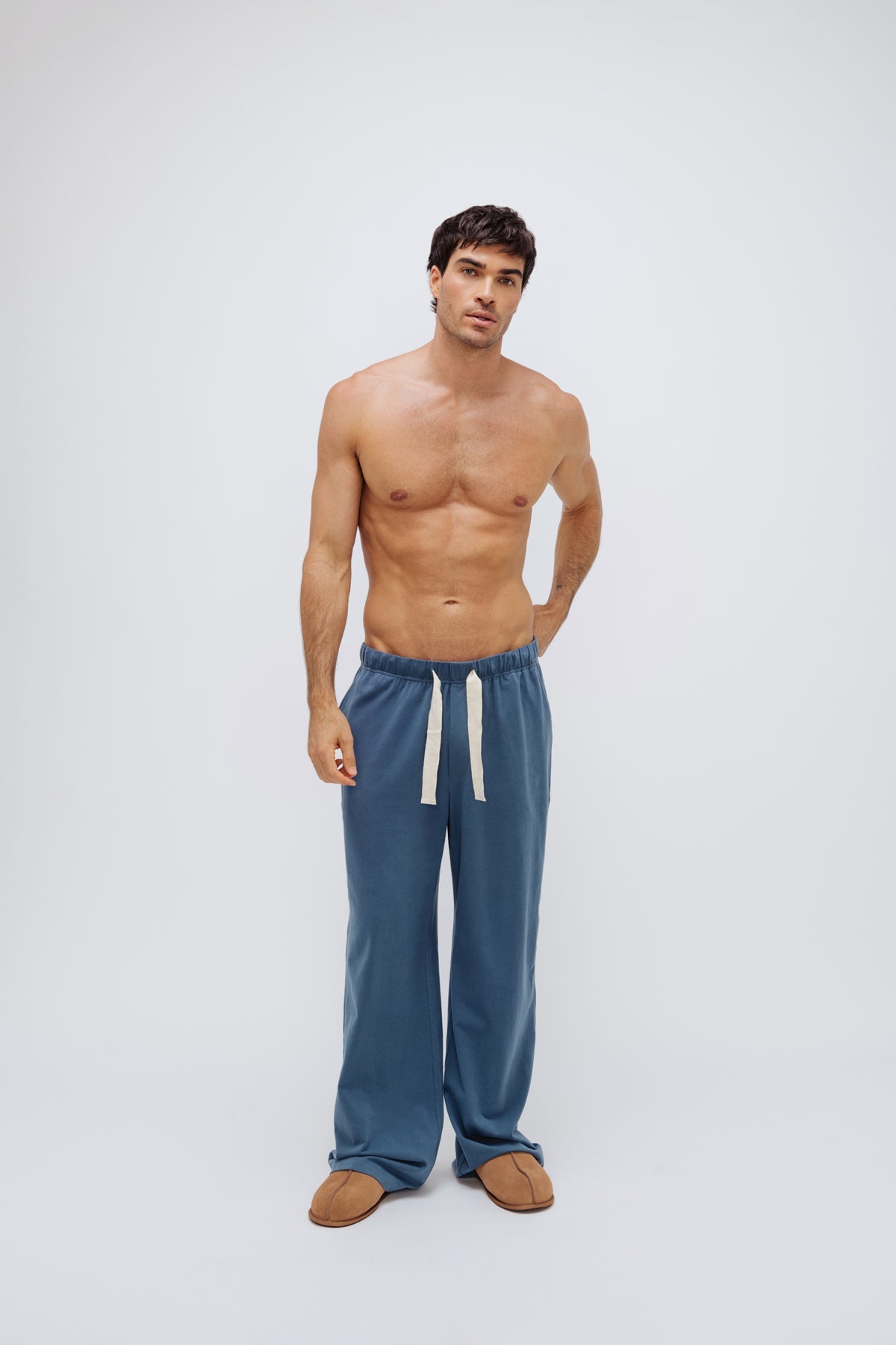 Cosy Pant in Noon worn by male model, front view showing natural cotton waist tie
