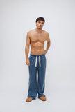 Cosy Pant in Noon worn by male model, front view showing natural cotton waist tie