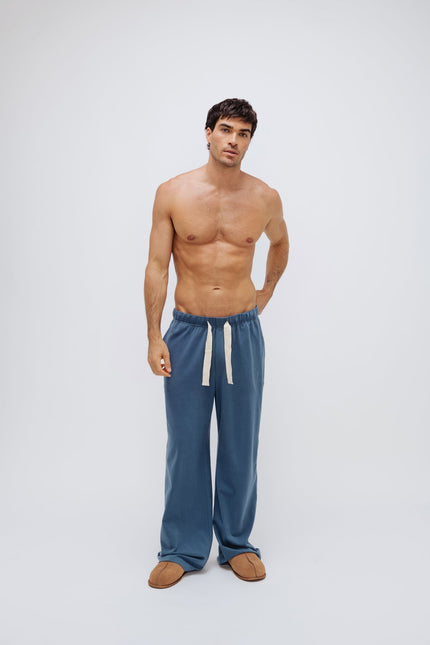 Cosy Pant in Noon worn by male model, front view showing natural cotton waist tie