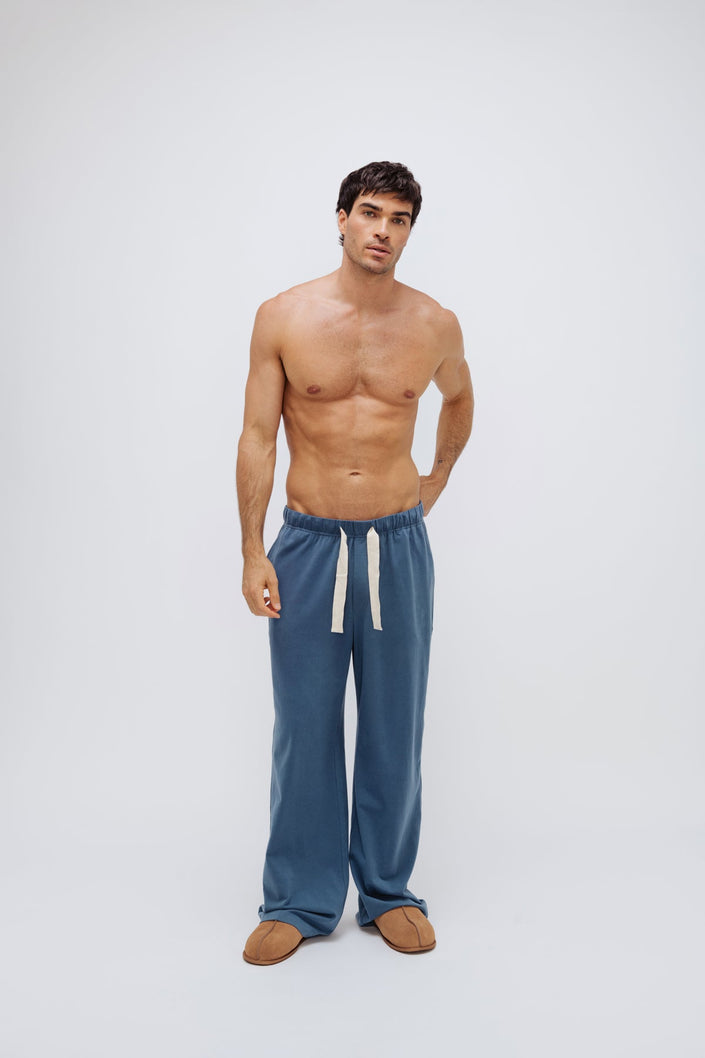 Cosy Pant in Noon worn by male model, front view showing natural cotton waist tie