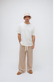 White Oversized Tee with a drop-shoulder silhouette made in organic cotton jersey, Oat Long Sleep Pant Macel and Oat Doona Hat worn by male model, front view