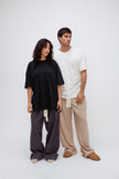 Black Oversized Tee and Long Sleep Pant Flannel in Evening Pinstripe worn by female model and White Oversized Tee with Oat Long Sleep Pant Flannel worn by male model, front view