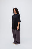 Black Oversized Tee in soft organic cotton jersey and Long Sleep Pant Flannel in Evening Pinstripe worn by female model, front side view
