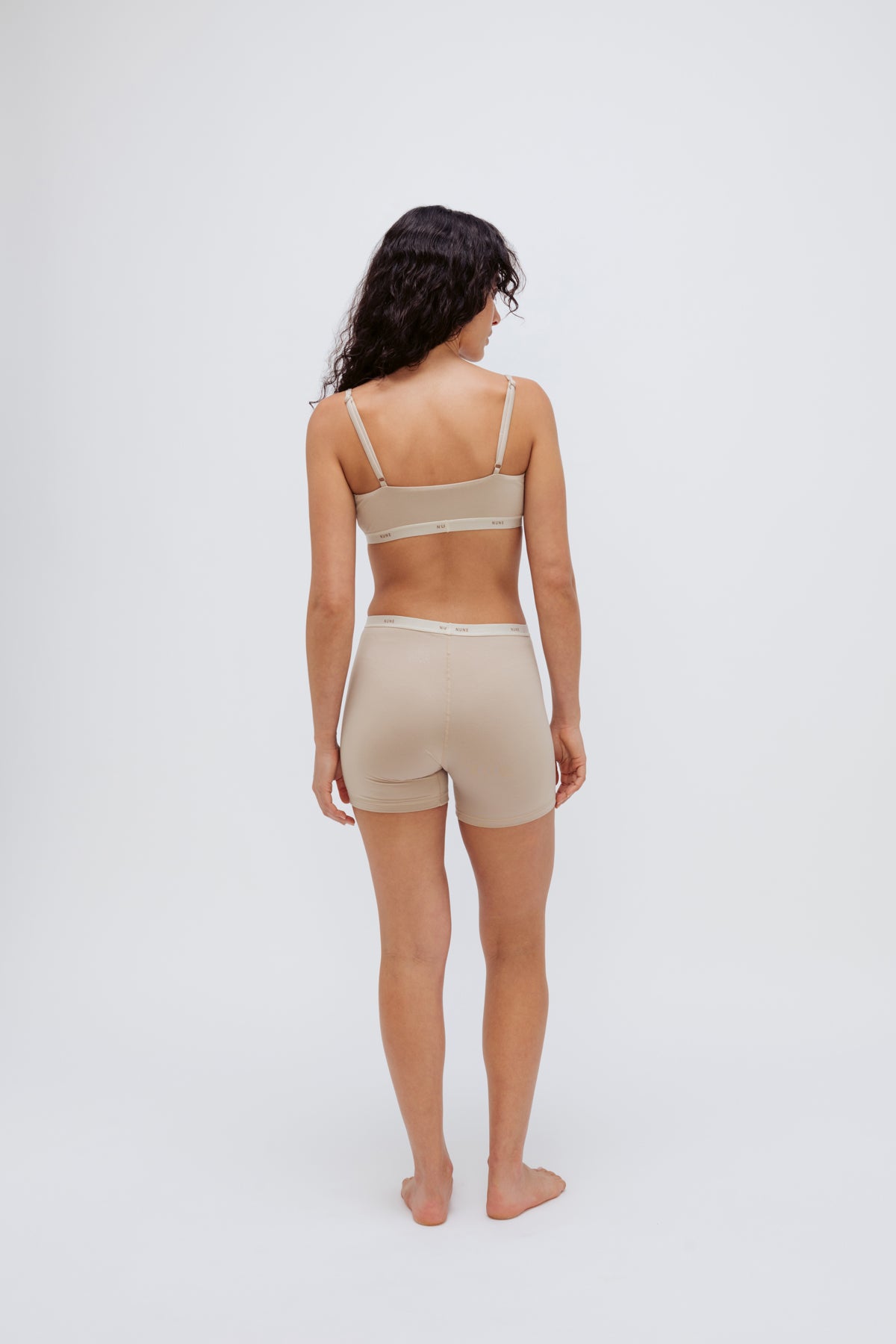 Women’s Boxer Brief in Latte silky-soft micromodal blend, like his Boxer Briefs, only cooler, and Square Neck Bralette in Latte worn by female model, back view