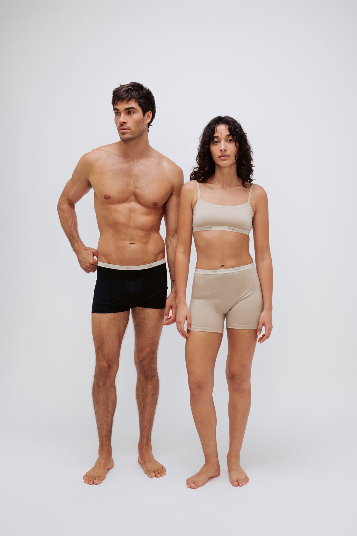 Women’s Boxer Brief in Latte silky-soft micromodal blend and Square Neck Bralette in Latte worn by female model and Black Original Boxer Briefs worn by male model, front view