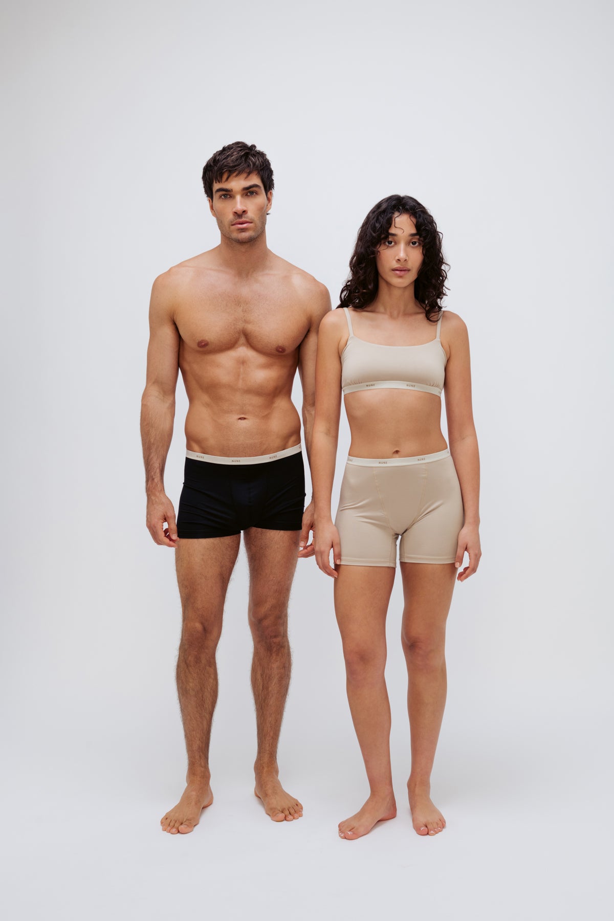 Women’s Boxer Brief in Latte silky-soft micromodal blend and Square Neck Bralette in Latte worn by female model and Black Original Boxer Briefs worn by male model, front view