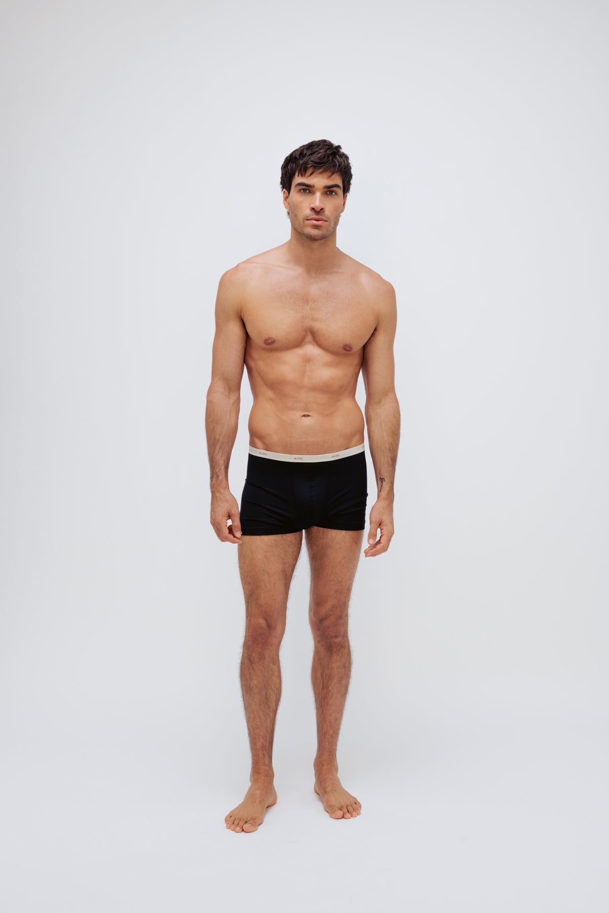 Men's black original briefs worn by model full front view