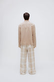 Oat long sleeve sleep shirt and flannel sleep pant in Oat Check being worn by male model, back view showing back pocket on pants. 