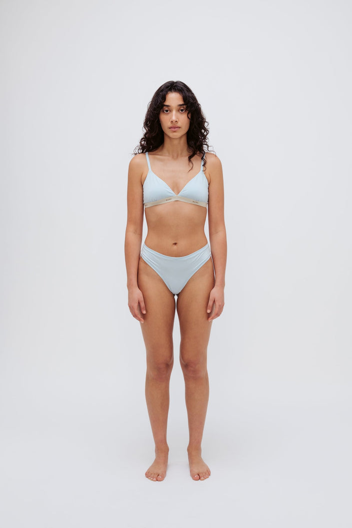 Triangle Bralette in daybreak silky-soft micromodal blend worn with women's daybreak g string by female model, front view