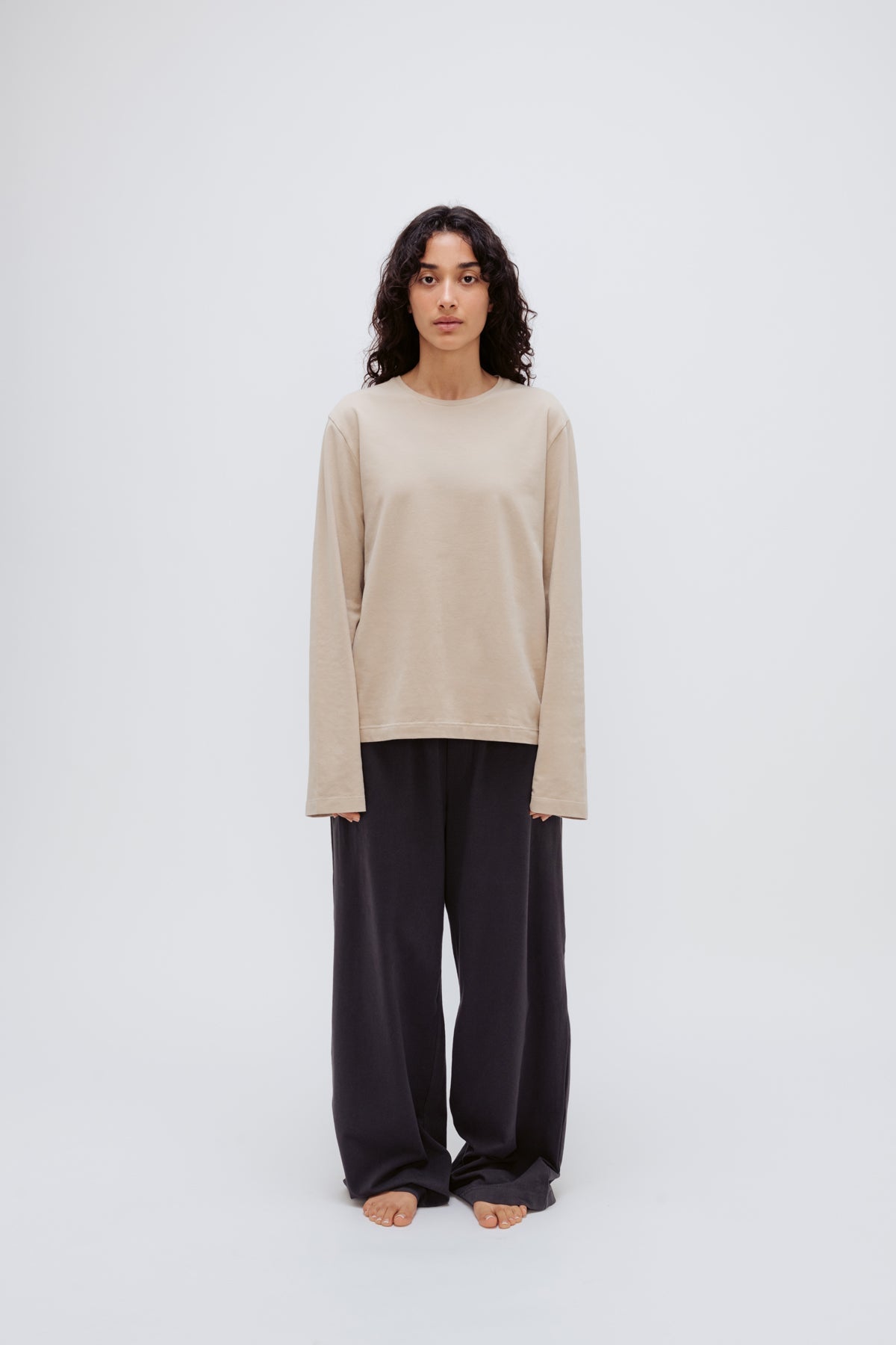 Cosy Long Sleeve Top in Latte and Cosy Pants in Charcoal worn by female model front view showing long sleeve length