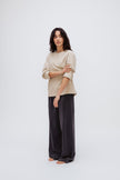 Cosy Long Sleeve Top in Latte and Cosy Pants in Charcoal worn by female model front side view with sleeves rolled up on arms