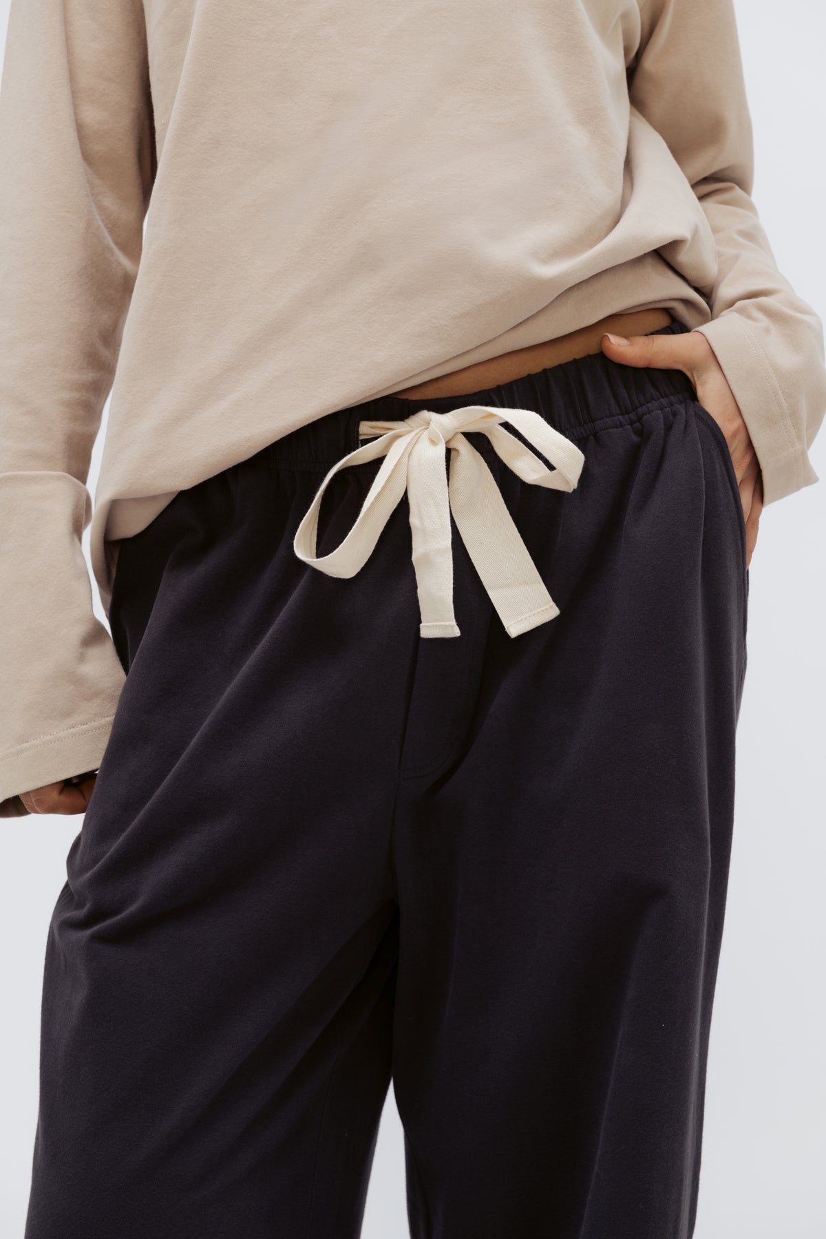 Cosy Pant in Charcoal and Cosy Top in Latte close up view showing waist detail on pants with natural cotton waist tie