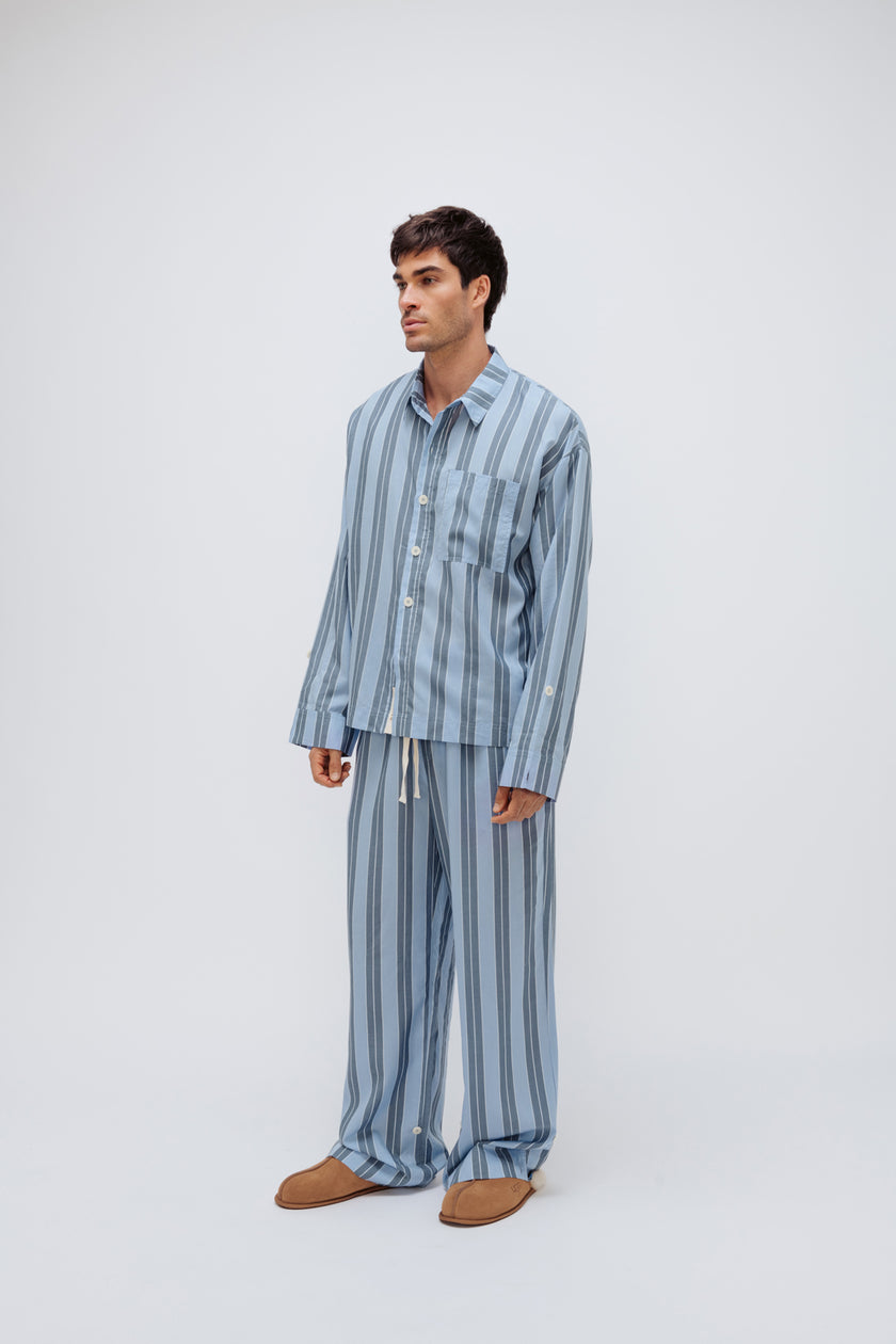 Blue Daybreak Stripe Long Sleeve Sleep Shirt and Pants in Macel worn by male model - facing off to the side