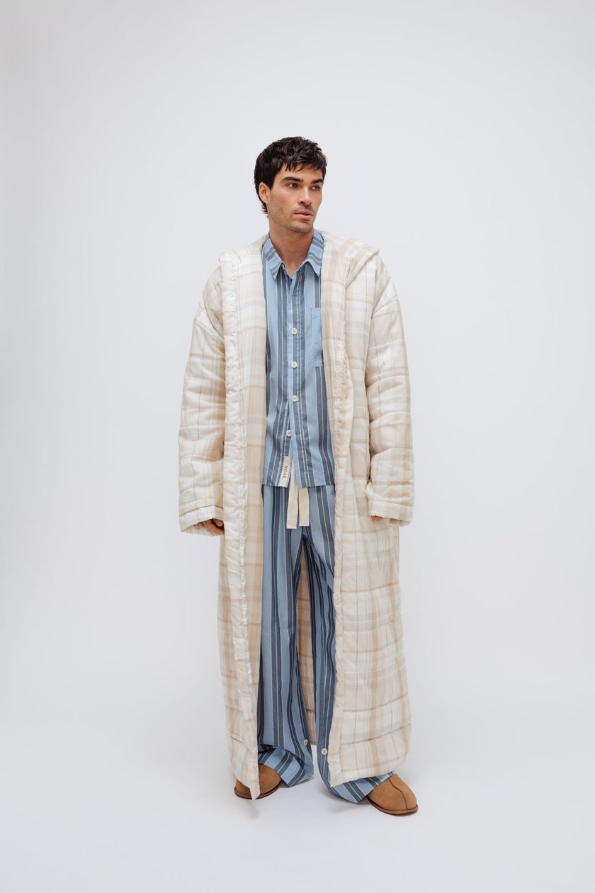 Long Doona Robe in Oat Check layered over Long Sleeve Sleep Shirt and Long Sleep Pants Macel in Daybreak stripe by male model, front view