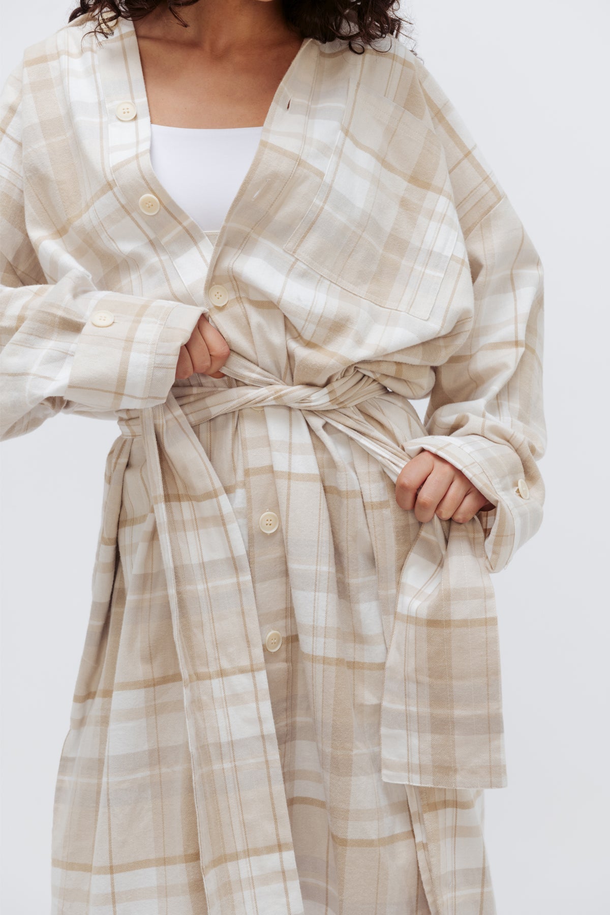 Oat Check House Shirt worn by female model, close up view of mid-section showing the removable waist tie being tied around her waist