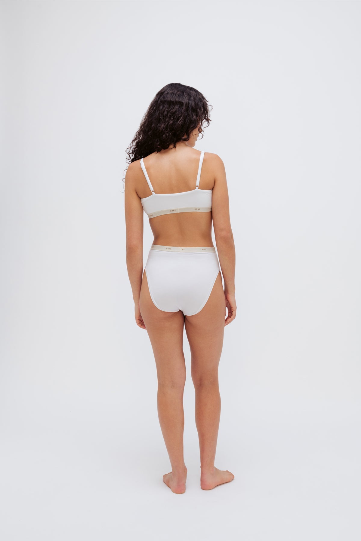Square Neck Bralette in white silky-soft micromodal blend worn with women's white high waisted briefs by female model, back view