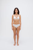 White triangle bralette and white mid brief worn by female model, front view showing flattering low neckline on bralette and double-lined front on briefs.