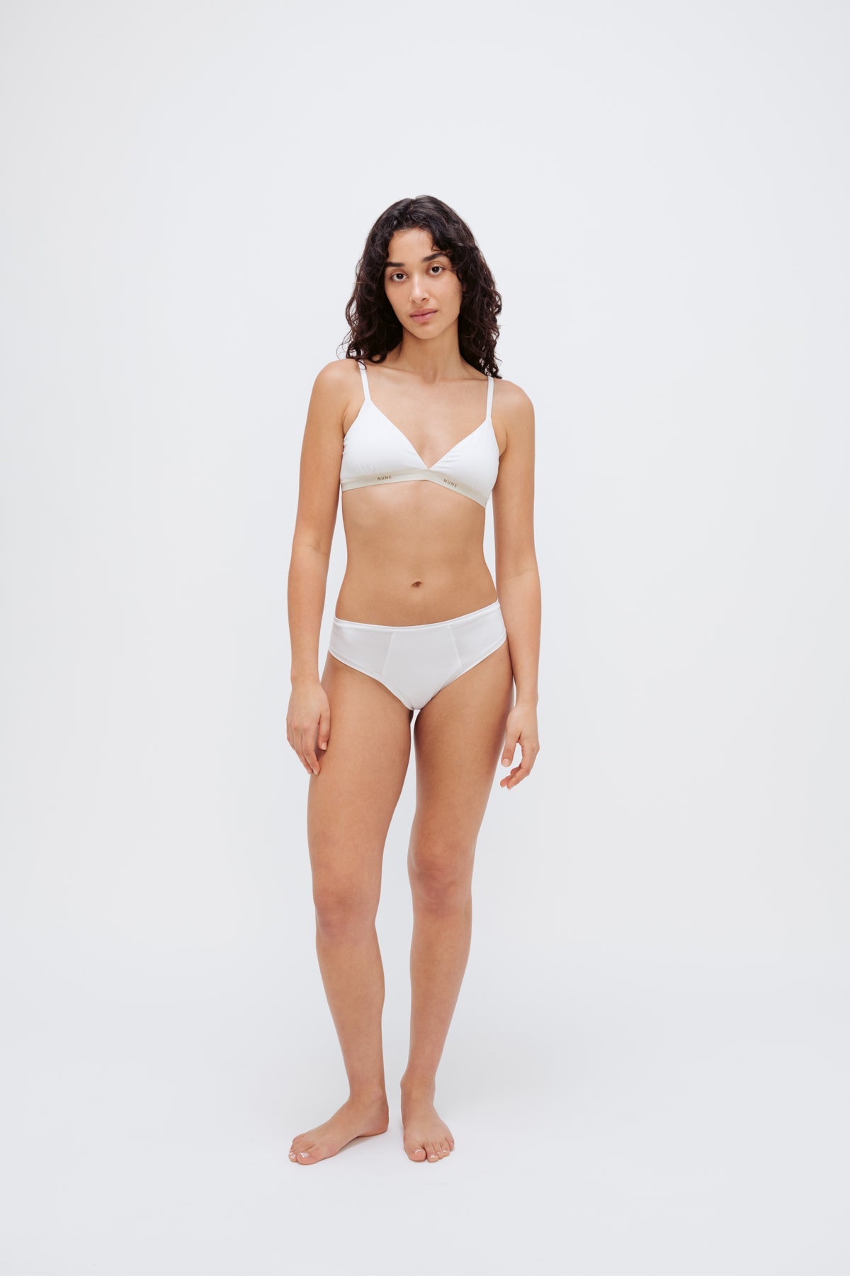 Triangle Bralette in white silky-soft micromodal blend worn with women's white mid briefs by female model, front view