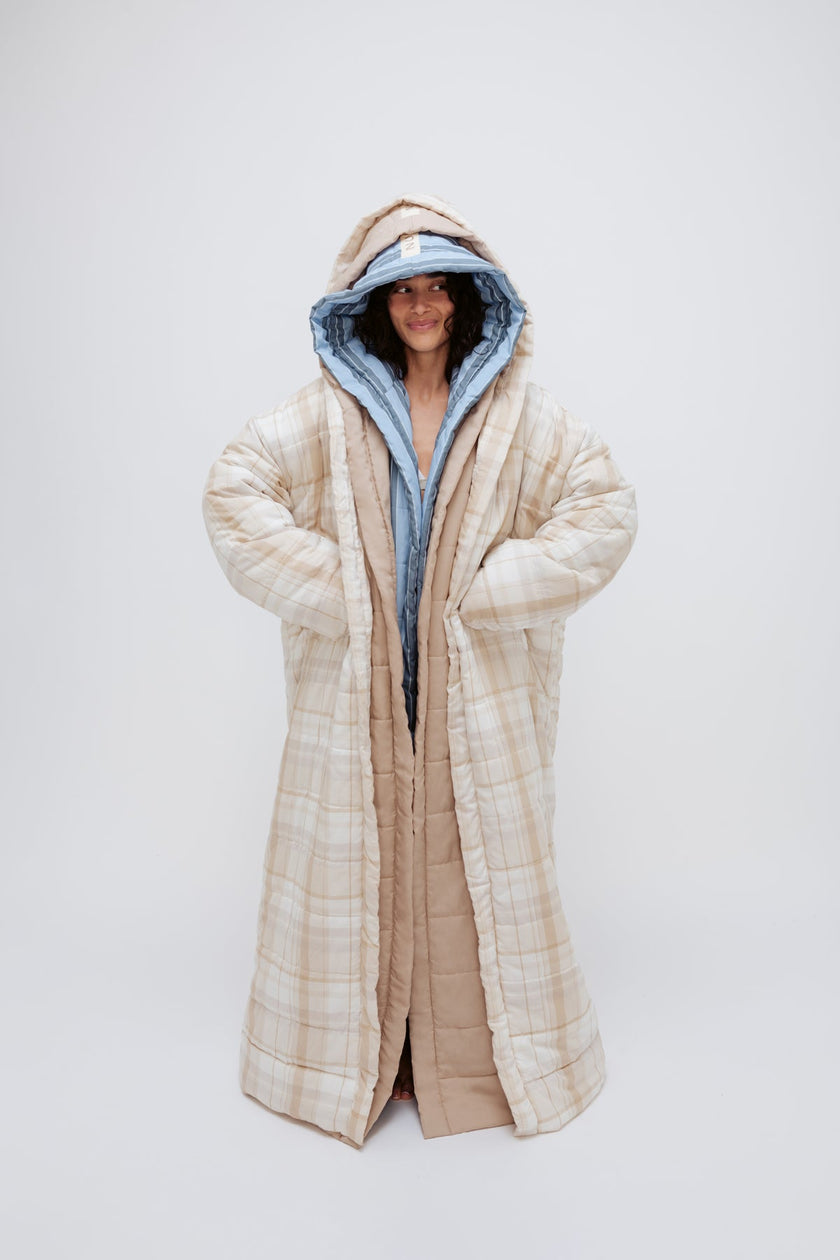 Long Doona Robes in Daybreak Stripe, Oat and Oat Check worn layered by female model smiling, full length view showing super long length of robes