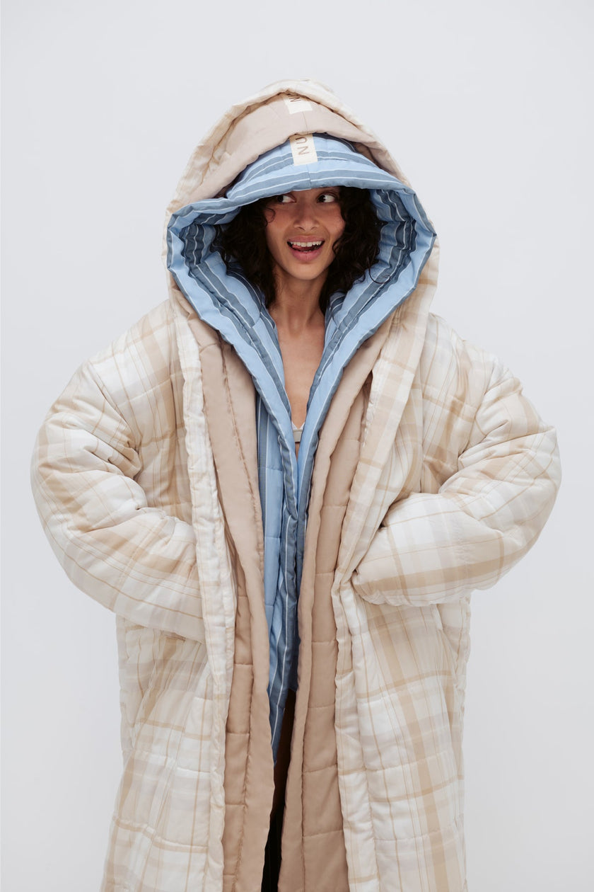 Long Doona Robes in Daybreak Stripe, Oat and Oat Check worn layered by female model smiling with all 3 robe hoods over her head
