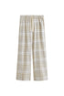 The flannel sleep pant in Oat Check. Adjustable length, a natural waist tie, and functional pockets make it a practical sleepwear essential.  Front view showing natural cotton waist tie and front pockets.
