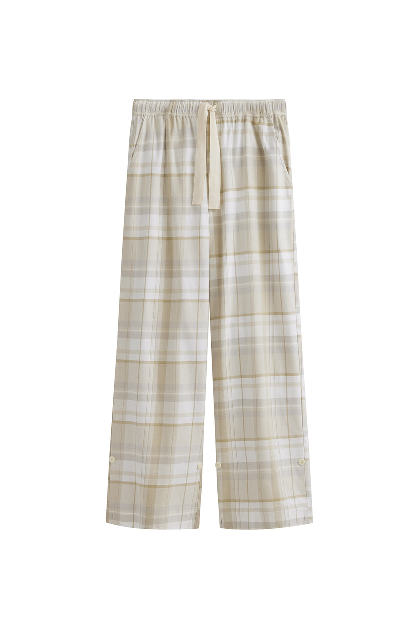 The flannel sleep pant in Oat Check. Adjustable length, a natural waist tie, and functional pockets make it a practical sleepwear essential.  Front view showing natural cotton waist tie and front pockets.