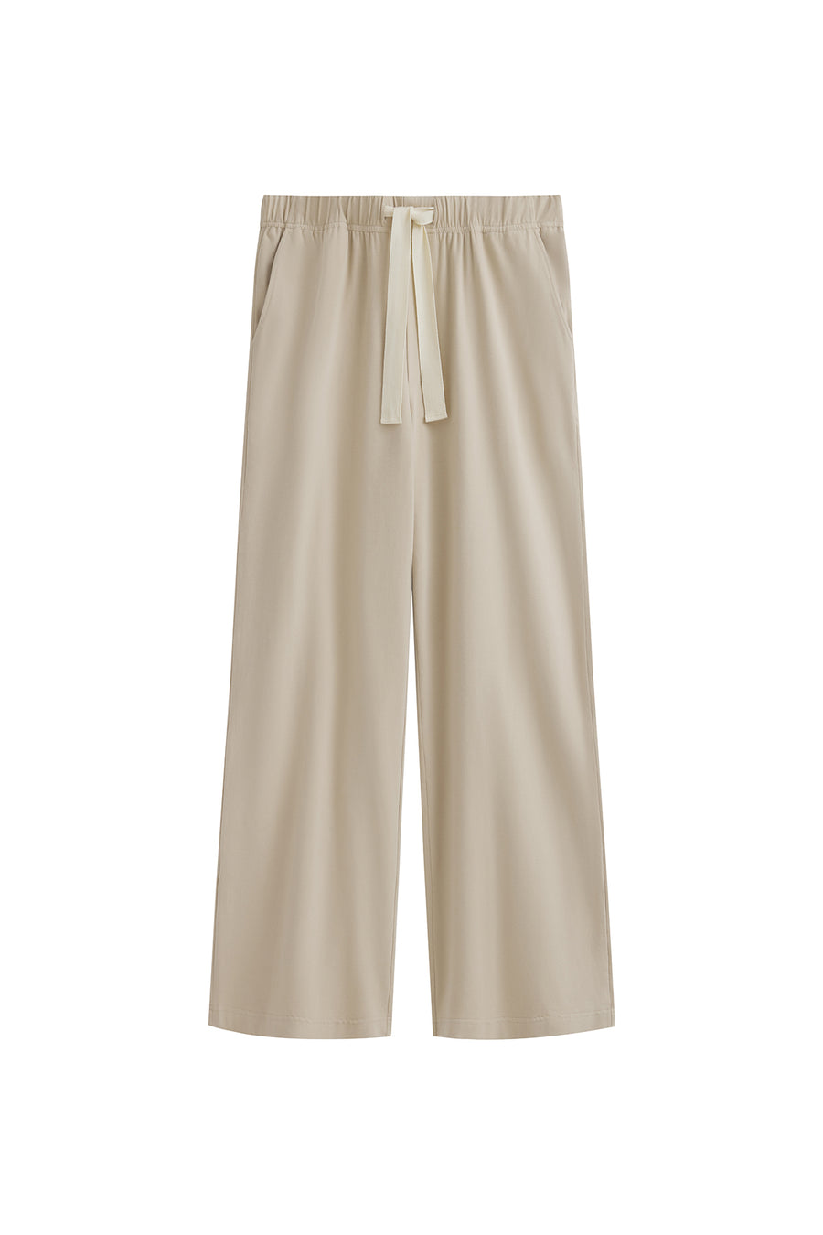 The Cosy Pant in Latte offers a refined alternative to traditional track pants. Front view showing front pockets and natural cotton waist tie.